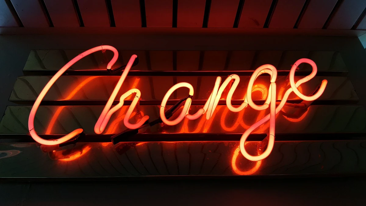 An orange neon sign that spells out the word "Change"