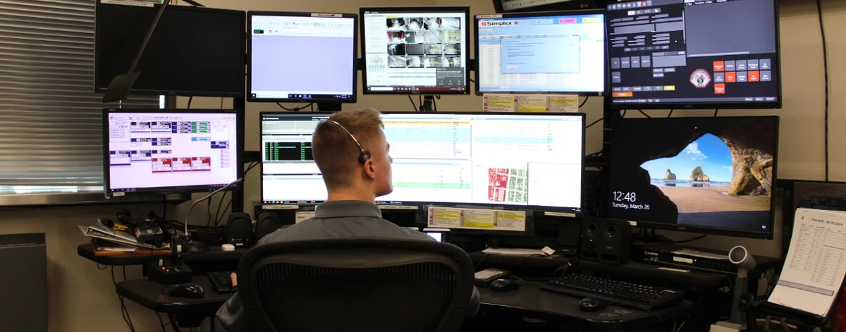 Featured image at top: An emergency communications dispatcher looks at a screen displaying the new 911 system. Photo by Kelly Cantwell.