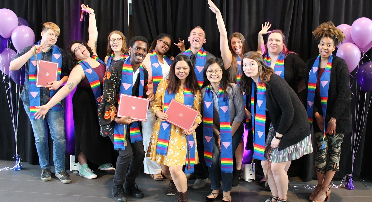 Students wearing rainbow graduation stoles and celebrating at Lavender Graduation